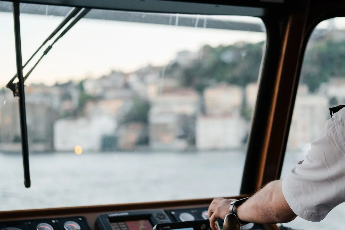 Trainee steering a ship from the helm during merchant navy training.
