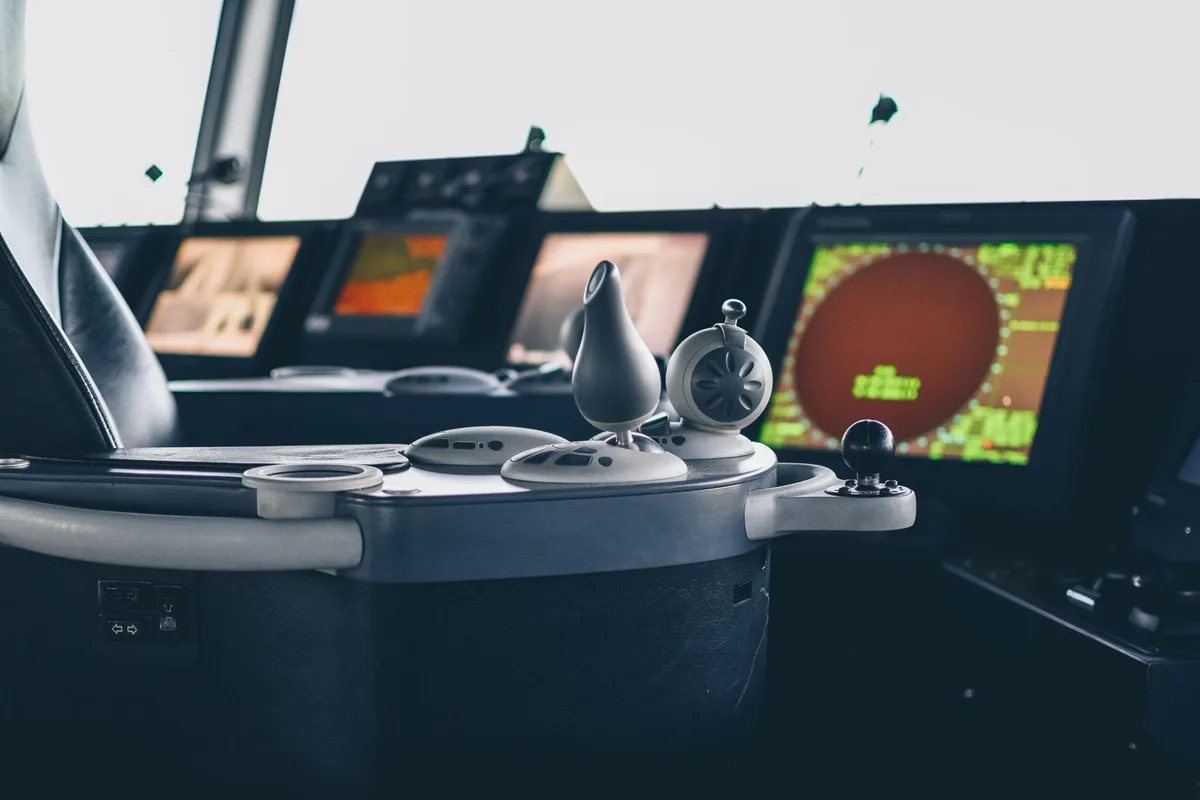 Radar and navigation controls on a ship bridge.