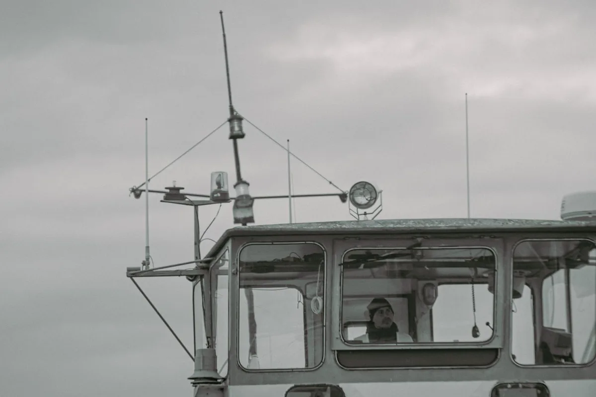 Ship captain navigating from the bridge, merchant seaman jobs guide.