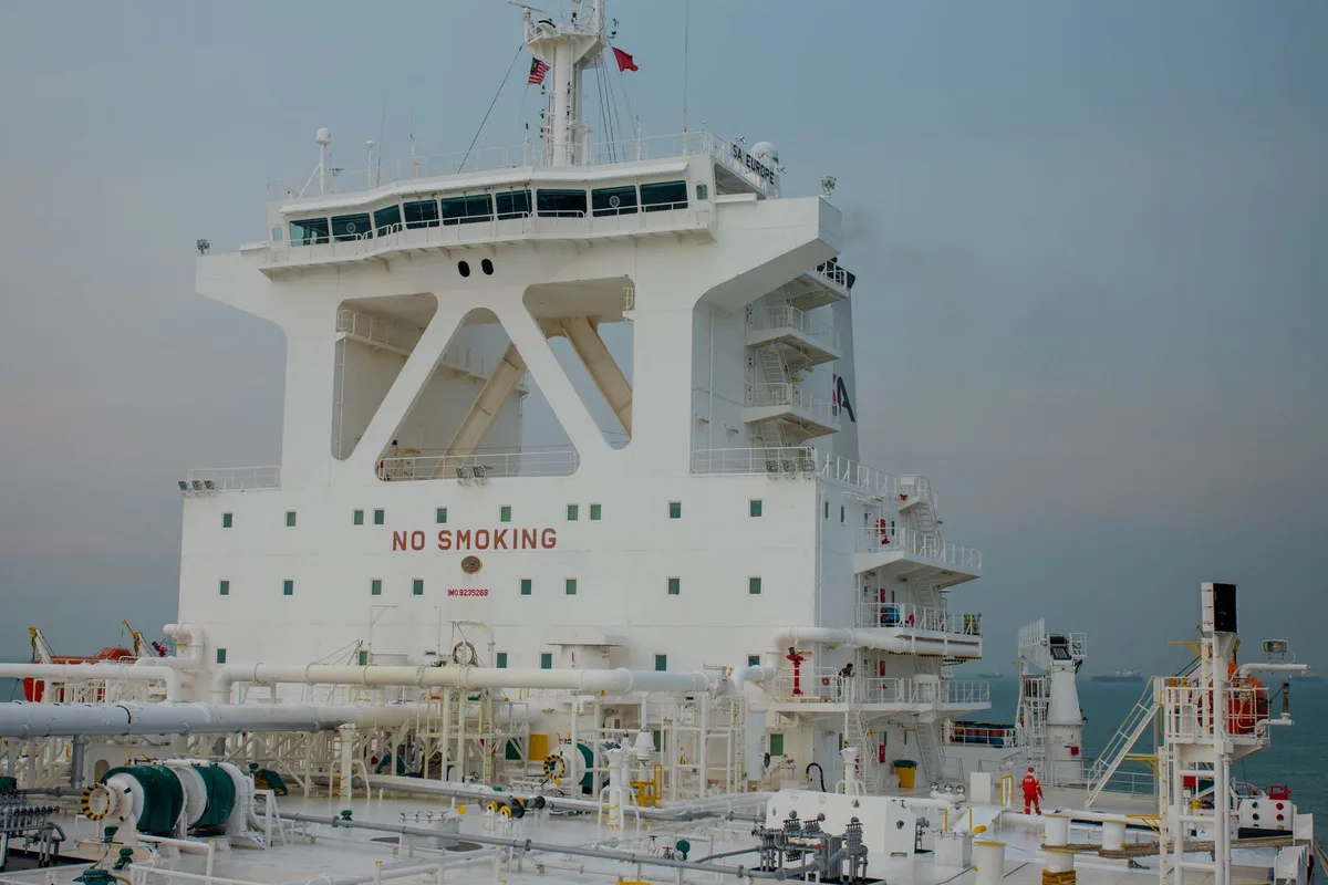 Crew member working on the deck of a tanker ship.