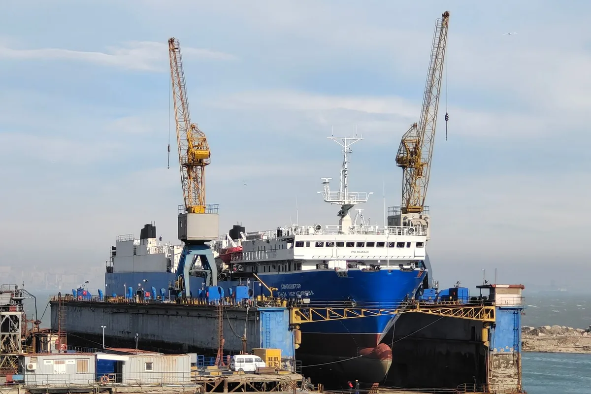 Large ship in a dry dock during ship repair in India.