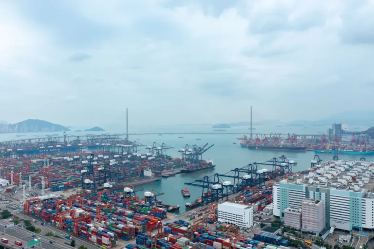 Aerial view of a large container port terminal with cranes and stacked containers