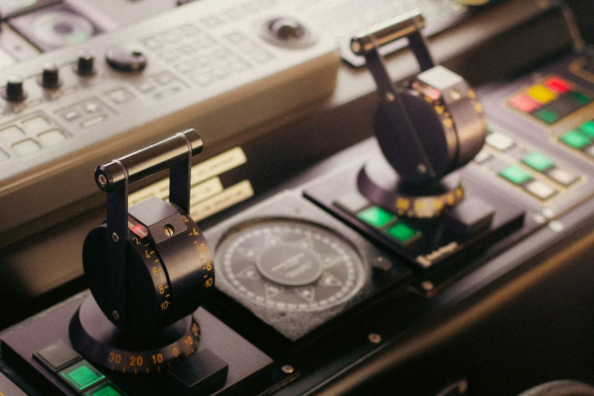 Compass and radio controls on a ship bridge used for GMDSS.